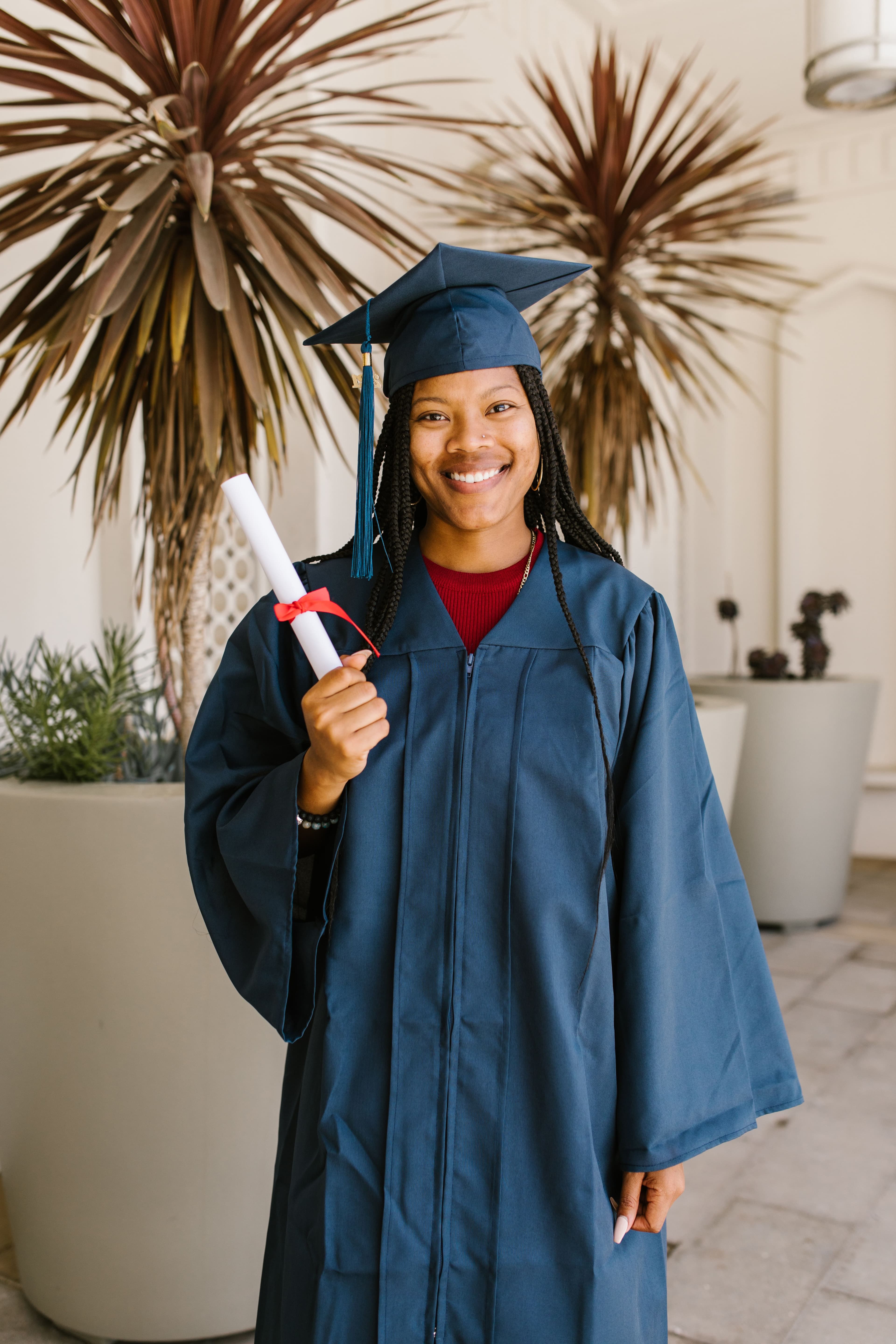 A recent graduate holding a diploma